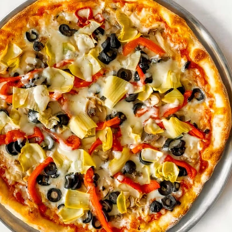 A Tuscan Bistro pizza topped with melted cheese, black olives, red peppers, and artichoke hearts.